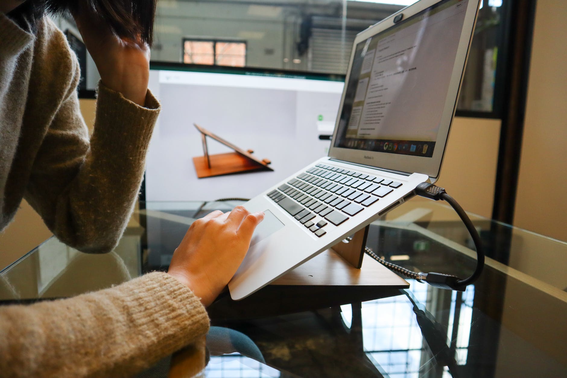 photo of a person using a gray laptop computer